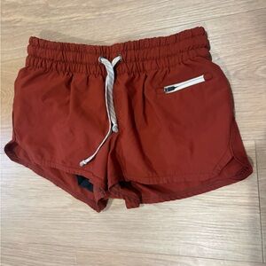 Vuori Women's Athletic Shorts in Rust